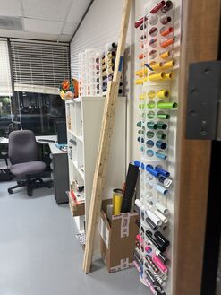 Vinyl and material racks by the window.